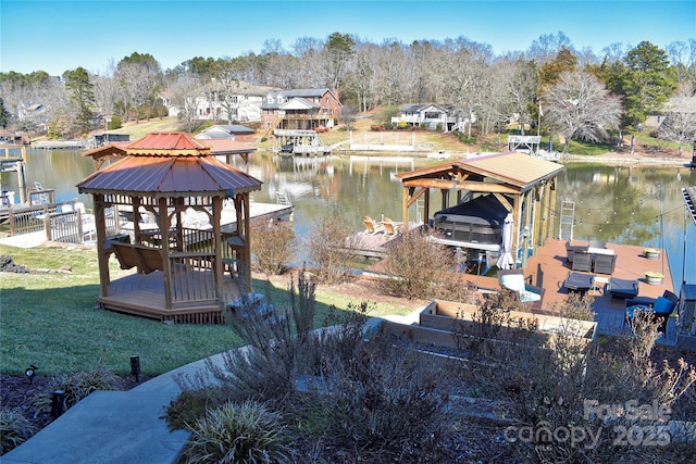 view of dock featuring a gazebo, a water view, a lawn, and fence