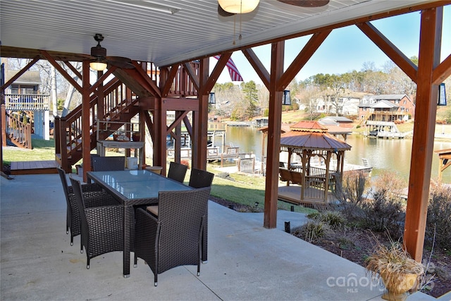 view of patio with a gazebo, stairs, a ceiling fan, and a water view