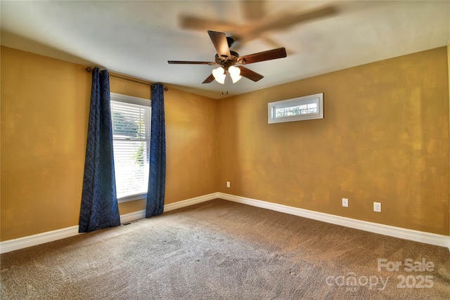 carpeted spare room featuring baseboards, plenty of natural light, visible vents, and a ceiling fan