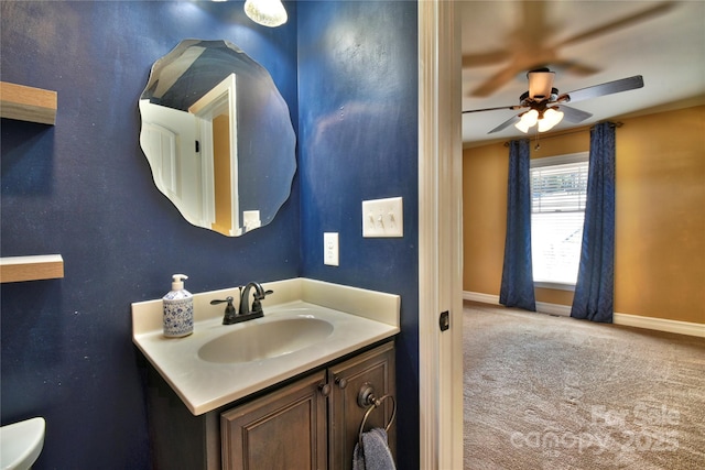 bathroom featuring vanity, baseboards, and a ceiling fan