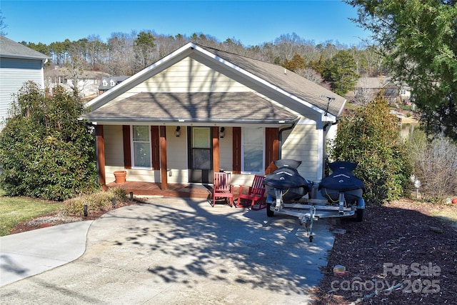 view of front of home featuring covered porch and roof with shingles