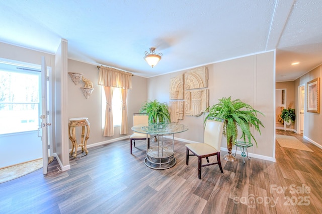 living area featuring ornamental molding and dark hardwood / wood-style floors