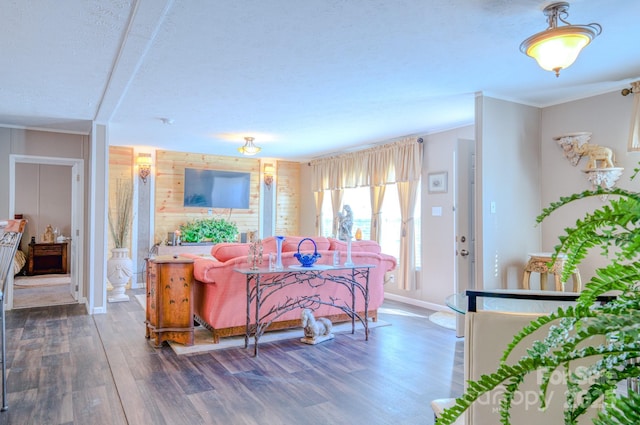 living room featuring dark wood-type flooring and ornamental molding