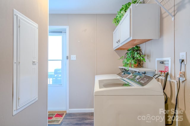 clothes washing area with independent washer and dryer, cabinets, a healthy amount of sunlight, and dark hardwood / wood-style flooring