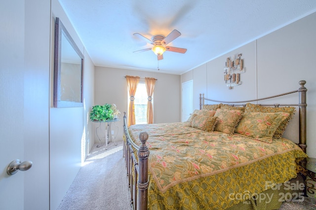 bedroom featuring ceiling fan, ornamental molding, and carpet flooring