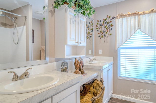 bathroom featuring vanity and a shower