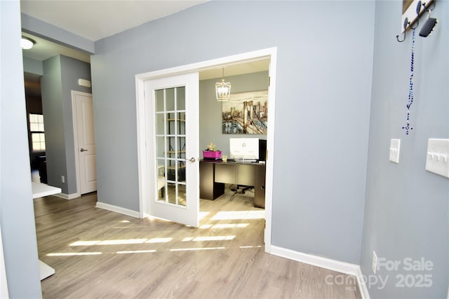 hall featuring wood-type flooring and french doors