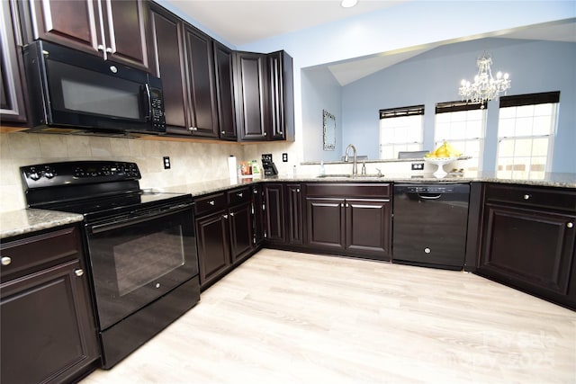 kitchen with dark brown cabinetry, sink, vaulted ceiling, and black appliances