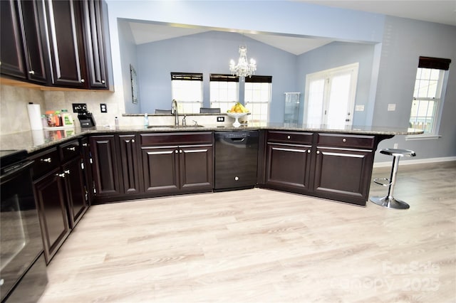 kitchen featuring sink, dishwasher, stone counters, plenty of natural light, and kitchen peninsula