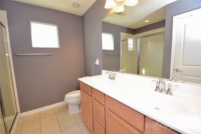 bathroom with vanity, a shower with shower door, tile patterned floors, and toilet