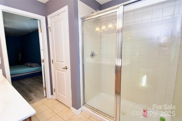 bathroom with an enclosed shower and tile patterned flooring