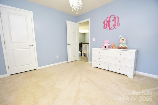 bedroom with light carpet and a notable chandelier