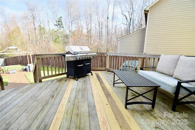 wooden deck featuring area for grilling and an outdoor hangout area