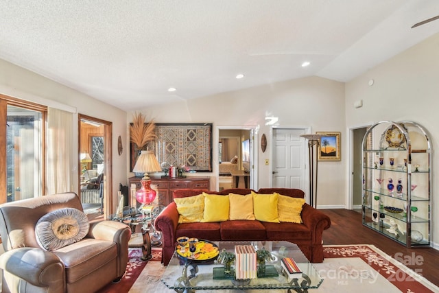 living room featuring lofted ceiling, recessed lighting, dark wood-type flooring, a textured ceiling, and baseboards