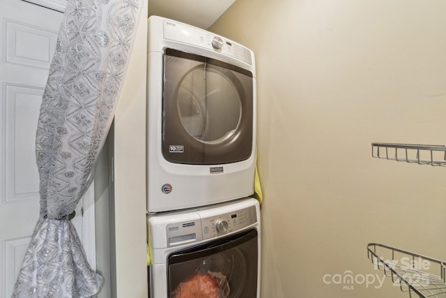 laundry room featuring laundry area and stacked washer / dryer