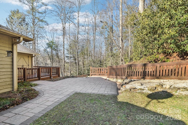 view of yard featuring a patio and a wooden deck