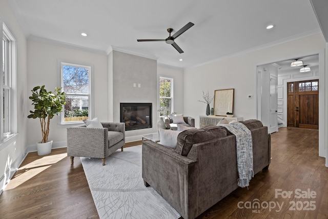 living room featuring plenty of natural light, dark wood-style flooring, and crown molding