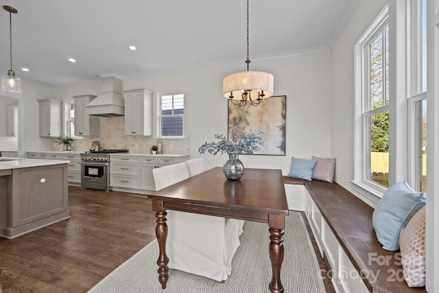 dining room featuring recessed lighting, dark wood-type flooring, a chandelier, and crown molding