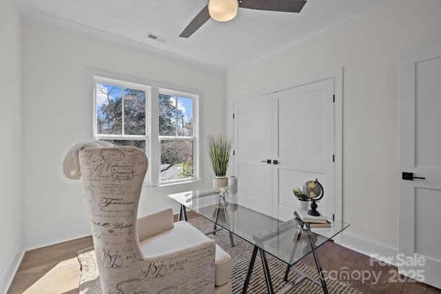 office space featuring visible vents, baseboards, wood finished floors, and a ceiling fan