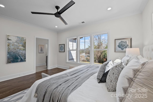 bedroom with visible vents, crown molding, baseboards, recessed lighting, and wood finished floors