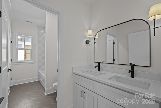 full bathroom with double vanity, visible vents, toilet, and a sink