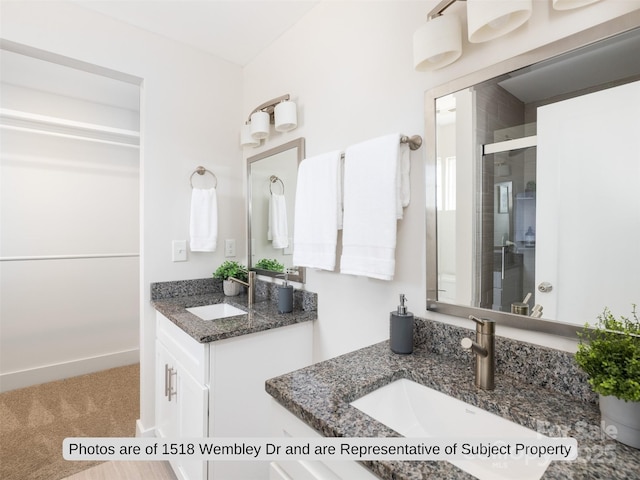 bathroom with vanity and a shower with shower door