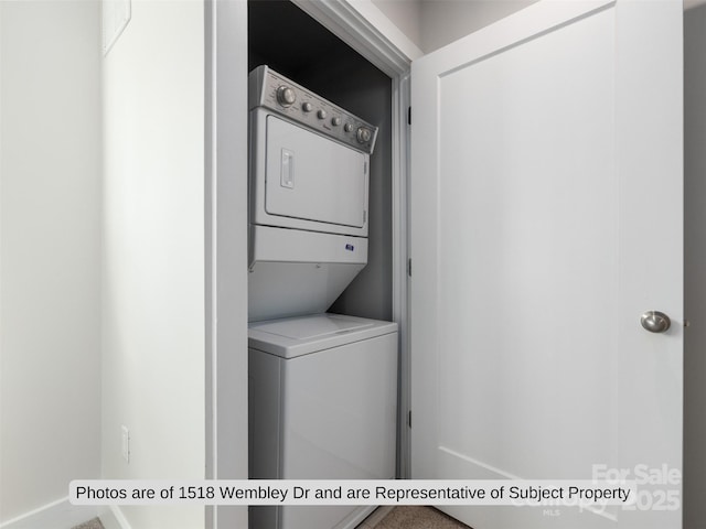 laundry area with stacked washer / drying machine