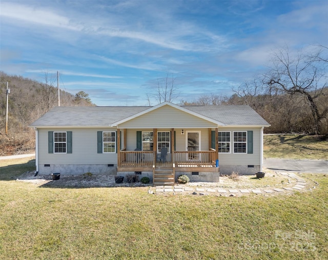 ranch-style home with a front yard and covered porch