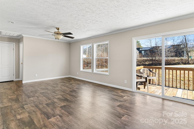 spare room featuring dark wood-type flooring, ornamental molding, and a healthy amount of sunlight