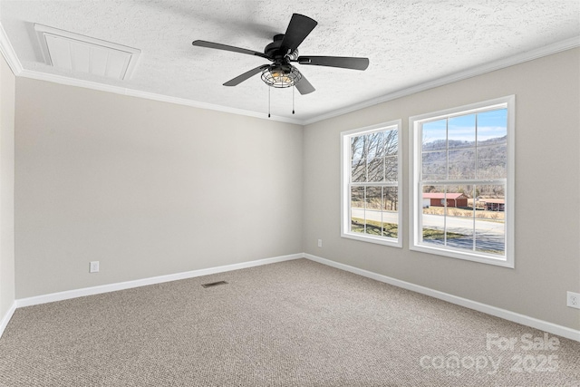 unfurnished room featuring a wealth of natural light, ornamental molding, a textured ceiling, and carpet