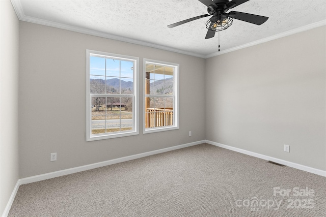 carpeted empty room featuring crown molding, ceiling fan, and a textured ceiling