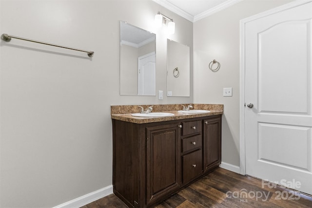 bathroom featuring ornamental molding, hardwood / wood-style floors, and vanity