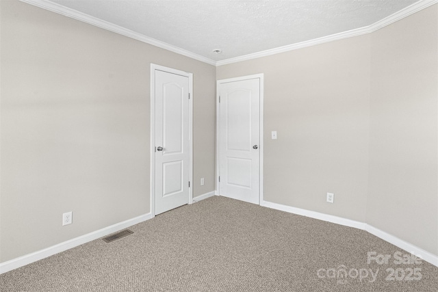 carpeted empty room with ornamental molding and a textured ceiling