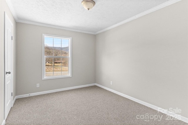 unfurnished room featuring carpet floors, ornamental molding, and a textured ceiling