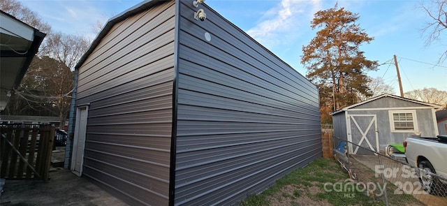 view of shed featuring fence