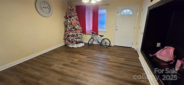 foyer featuring baseboards and wood finished floors