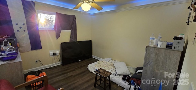 bedroom featuring a ceiling fan, crown molding, baseboards, and wood finished floors