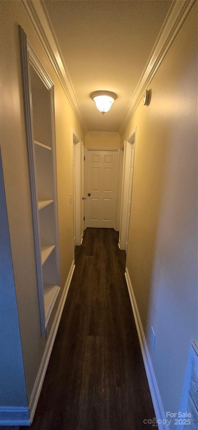 hall featuring ornamental molding, wood finished floors, and baseboards