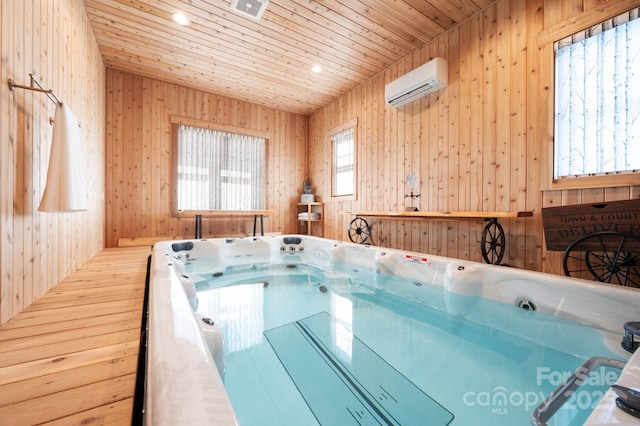 view of pool featuring a wall unit AC and an indoor hot tub