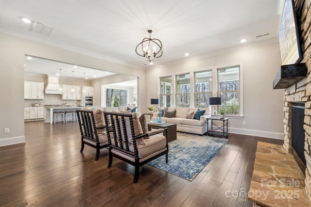 living room with ornamental molding, a fireplace, dark wood finished floors, and visible vents