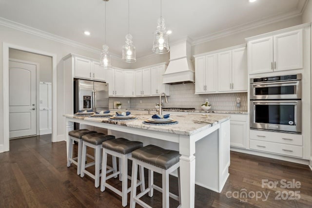 kitchen featuring ornamental molding, appliances with stainless steel finishes, and custom exhaust hood