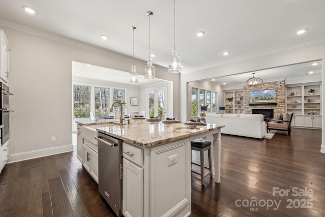 kitchen featuring a wealth of natural light, open floor plan, a sink, and stainless steel dishwasher