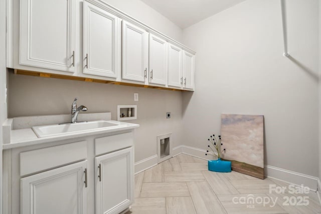 laundry area with washer hookup, cabinet space, a sink, electric dryer hookup, and baseboards