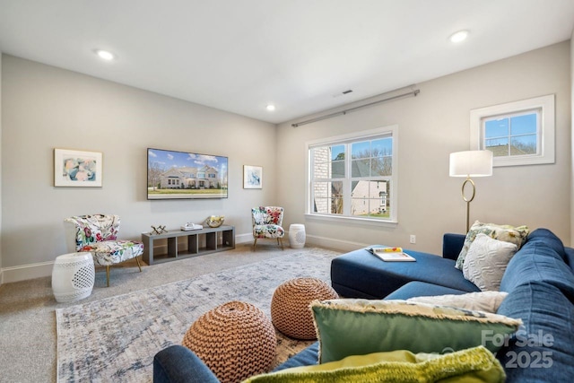 carpeted living area with recessed lighting, visible vents, and baseboards