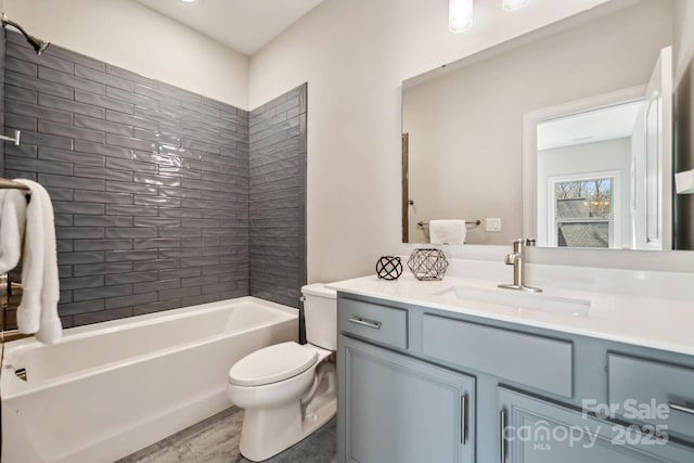 full bath featuring wood finished floors, vanity, toilet, and bathing tub / shower combination