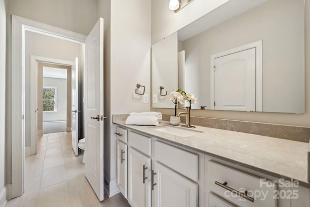 bathroom with vanity, toilet, and tile patterned floors