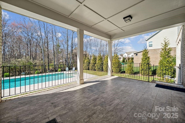 view of patio / terrace featuring a fenced in pool and fence