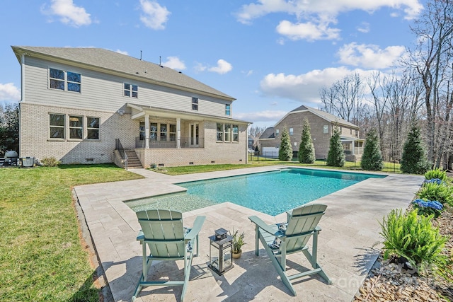 outdoor pool with a lawn and a patio