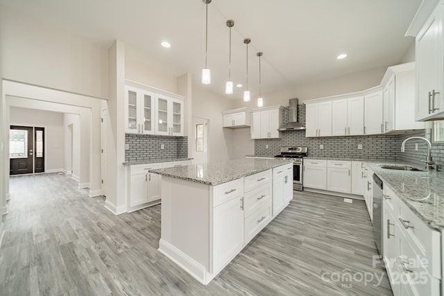 kitchen with white cabinetry, stainless steel appliances, and a center island