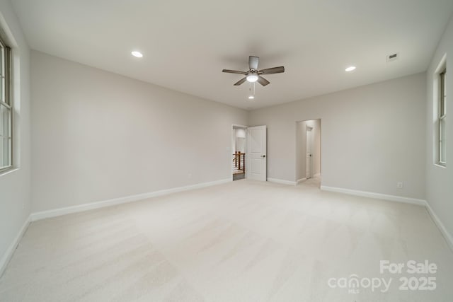 unfurnished bedroom featuring light colored carpet and ceiling fan